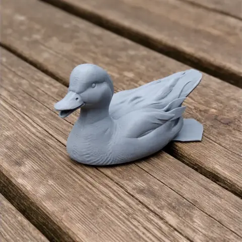 3D-printed model of an American wigeon on a wooden surface.