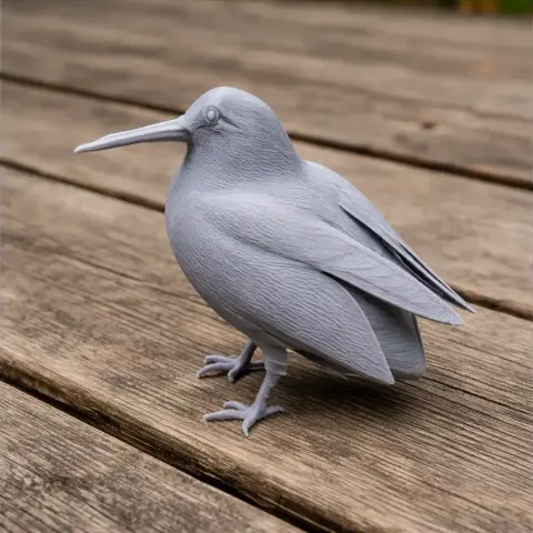 Detailed 3D printed model of a bird, resembling an American woodcock, on a wooden surface.