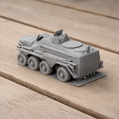 3D printed model of an Alvis Saracen tank on a wooden surface.