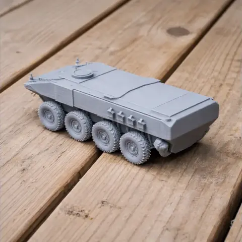 Gray 3D printed model of an amphibious combat vehicle with multiple wheels on wooden surface.