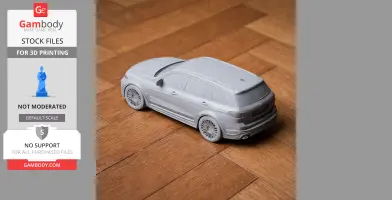 3D-printed model of a BMW X7 on a wooden floor, showcasing detailed design and wheels.