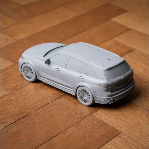 3D printed BMW X7 model on a wooden surface.