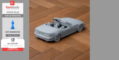 3D-printed BMW Z1 model on wooden surface, showcasing convertible design with detailed interior and wheels.