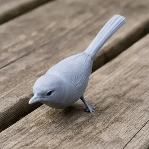 3D-printed ancient antwren model with detailed feathers, perched on wooden surface.