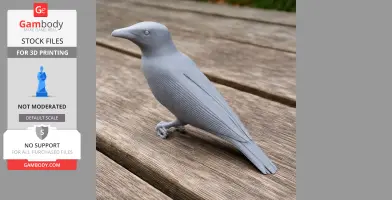 A gray 3D-printed bird model is displayed on a wooden surface.
