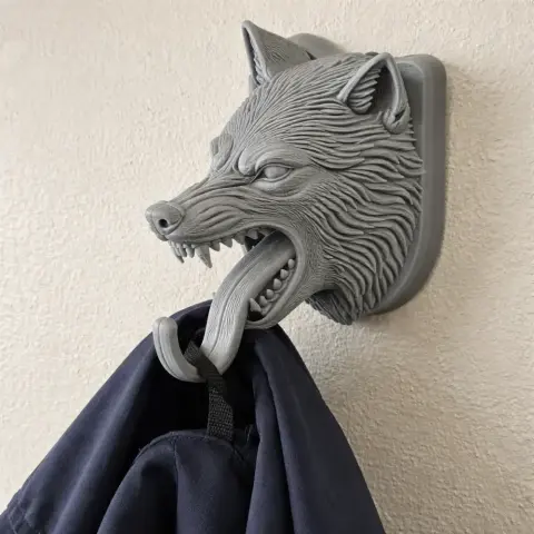 A detailed wolf head wall hanger with a hook for coats or keys.