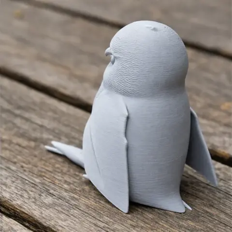3D-printed Andaman scops owl model with textured feathers, resting on a wooden surface.