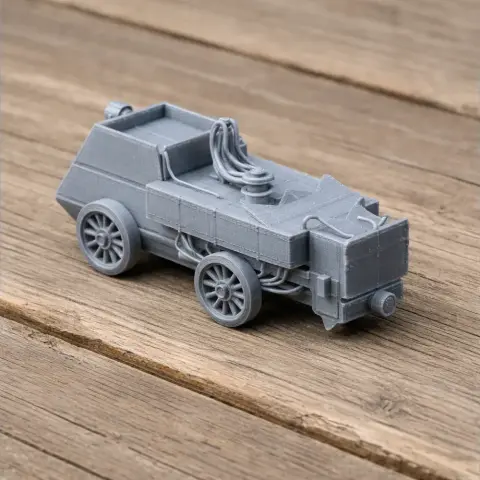 Gray 3D-printed model of an armored vintage autocar with detailed wheels and surface features.