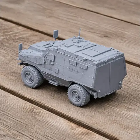 A detailed 3D-printed armored personnel carrier model on a wooden surface.