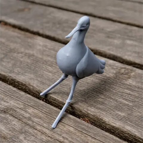 A 3D-printed model of a bird with long legs and a slender beak, posed on a wooden surface.