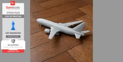 3D printed model of a Boeing 777 airplane, displayed on a wooden surface.