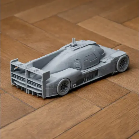 3D-printed BR Engineering BR1 scale model on wooden surface, highlighting aerodynamic design.