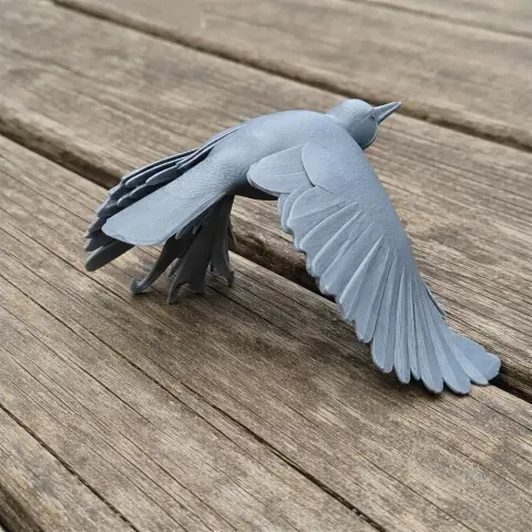 Gray 3D model of an Andean flicker bird in mid-flight on a wooden surface.