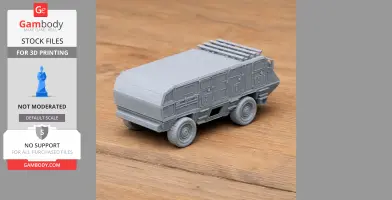 3D-printed model of an armored vehicle with detailed exterior on a wooden surface.