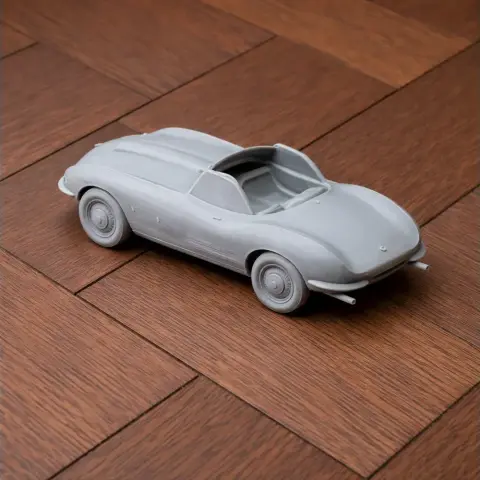 3D-printed model of a Bristol Bullet car on a wooden surface.