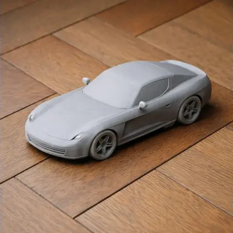 3D printed model of a sleek Bristol Fighter car on a wooden surface.