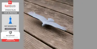 A 3D printed model of a bird with outstretched wings, placed on a wooden surface.