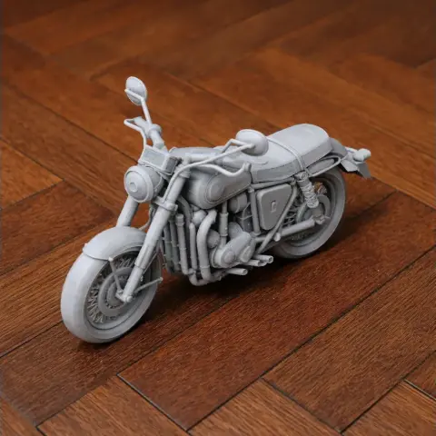 3D-printed model of a classic BSA Gold Star motorcycle on a wooden surface.