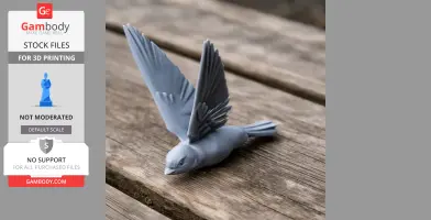 3D-printed model of a prehistoric swallow with wings spread, placed on a wooden surface.