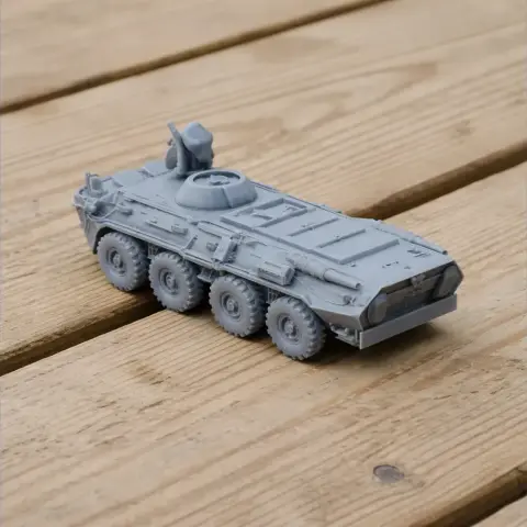 A 3D-printed model of a B-33 Zimbru tank with six wheels, on a wooden surface.