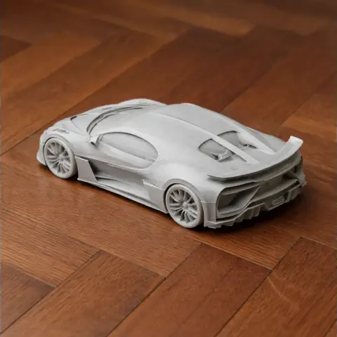 3D-printed model of a Bugatti car on a wooden floor.