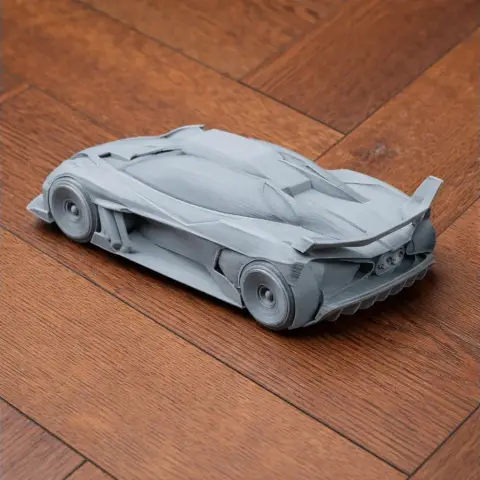 3D printed model of a Bugatti Bolide car on a wooden surface.