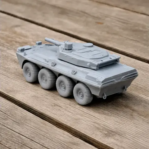 Gray 3D-printed model of a B1 Centauro tank with eight wheels on a wooden surface.