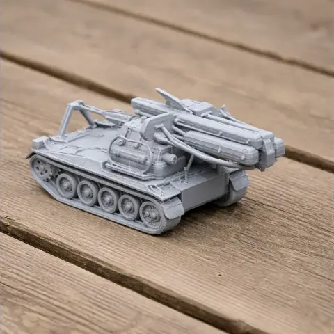 3D printed model of a Bandkanon 1 tank with tracks and cylindrical structures, displayed on wooden surface.