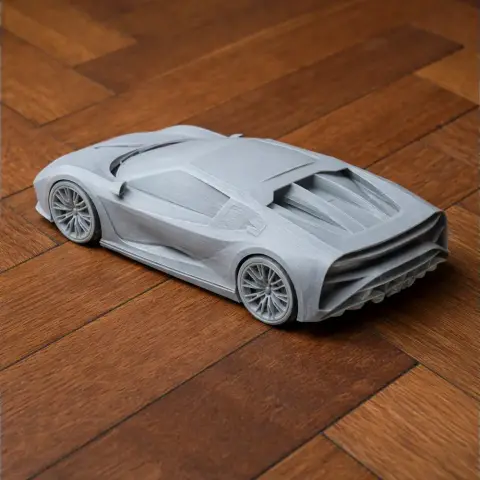 3D-printed Bugatti Centodieci model on a wooden surface, showcasing detailed features and sleek lines.