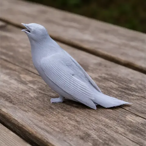 A 3D printed model of a prehistoric bird, detailed and perched on a wooden surface.