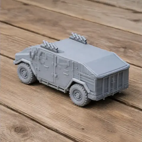 3D-printed model of an armored military vehicle on a wooden surface.