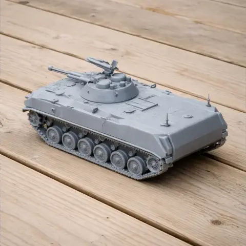 Gray 3D-printed model of a BMD-1 tank on a wooden surface.