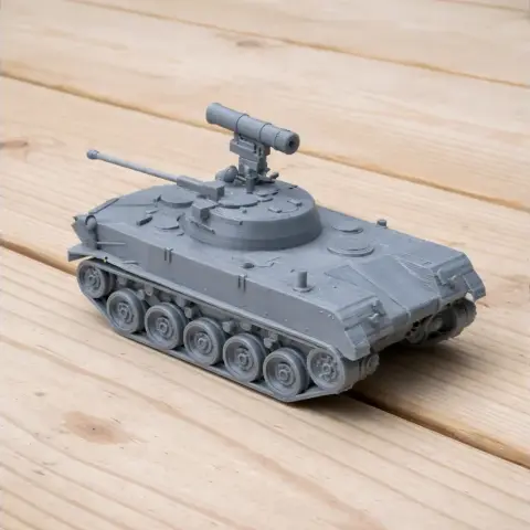 Gray 3D-printed BMD-2 tank model with detailed turret and tracks, displayed on wooden surface.