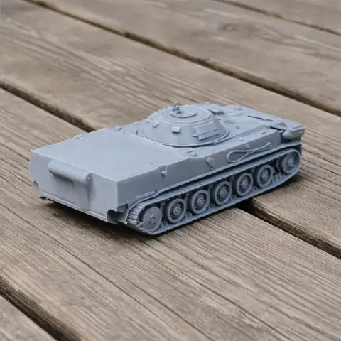 3D-printed model of a gray BMD-3 tank on a wooden surface.
