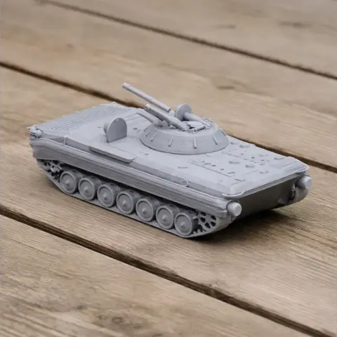 Gray 3D-printed BMP-1 tank model with detailed turret and tracks, displayed on a wooden surface.