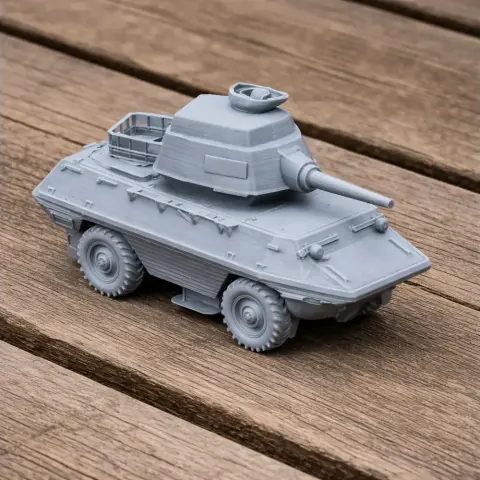 Gray 3D-printed model of an armored personnel carrier (APC) with a turret on wooden surface.