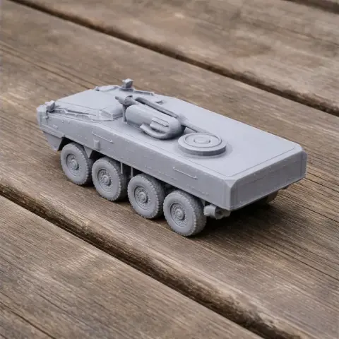3D-printed model of an eight-wheeled armored vehicle on a wooden surface.