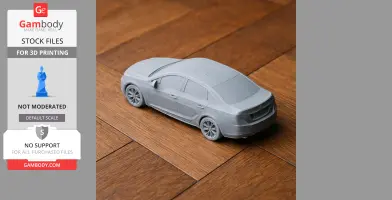 Gray 3D-printed Buick model on wooden floor, displayed for scale vehicle STL files.