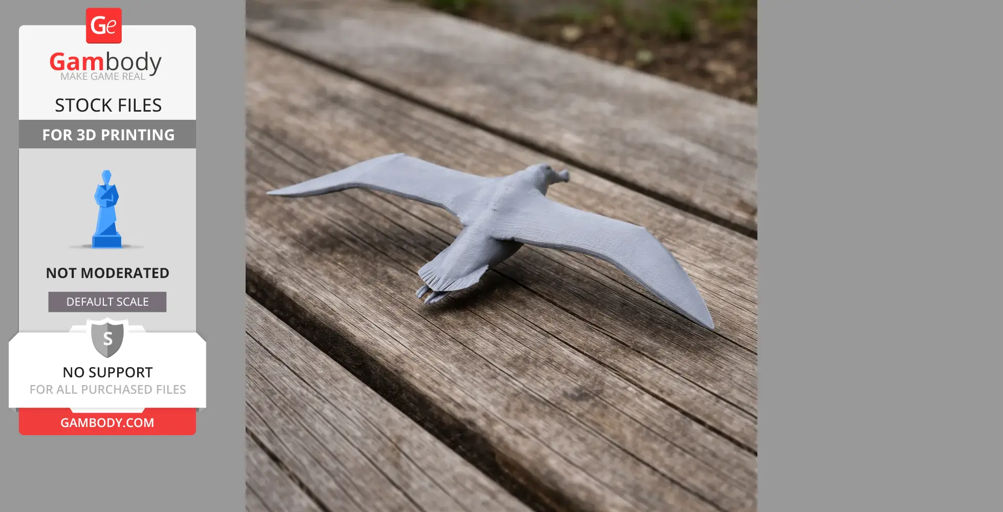 Gray 3D-printed model of a flying albatross on a wooden surface.