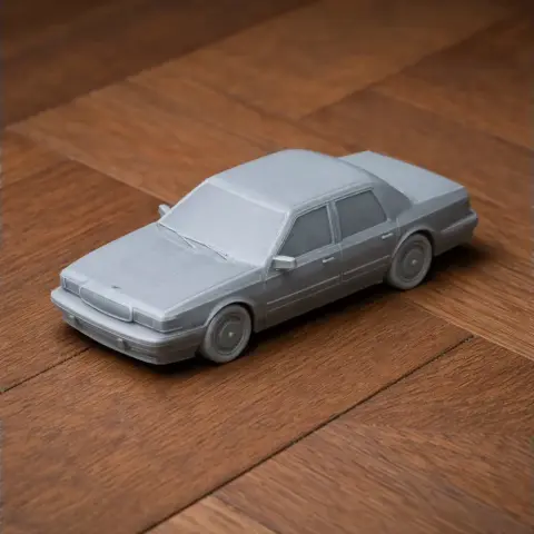 Gray 3D-printed model of a Buick Century car on a wooden surface.