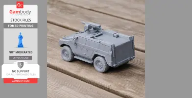 3D-printed model of a gray armored military vehicle with mounted turret on a wooden surface.