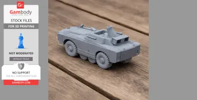 Gray 3D-printed model of a BRDM-1 armored vehicle on a wooden surface.