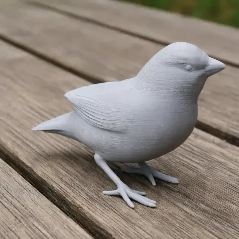 3D printed model of a small bird with detailed feathers, standing on a wooden surface.