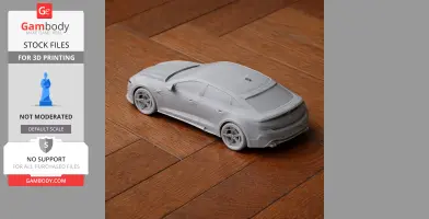 A gray 3D-printed scale model of a BYD Auto vehicle on a wooden surface.