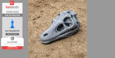 Gray 3D-printed Hadrosaurus skull replica resting on a textured sandy surface.