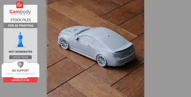 A 3D printed model of a Cadillac ATS-V, shown on a wooden surface.