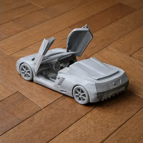 3D-printed model of a Cadillac Cien with gullwing doors open on a wooden surface.