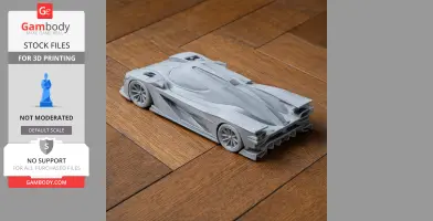 3D-printed model of a sleek Cadillac DPi-V.R race car on wooden floor.
