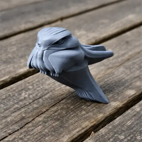 3D printed model of a stylized Archbold's nightjar with unique geometric features on wood surface.