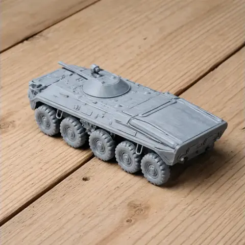 Gray 3D-printed model of a BTR-7 tank with eight wheels and detailed turret on wooden surface.
